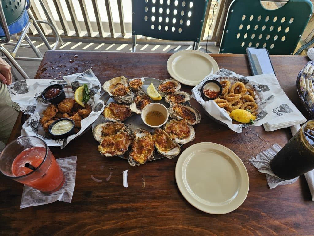 Table with oysters onion rings and crabcakes